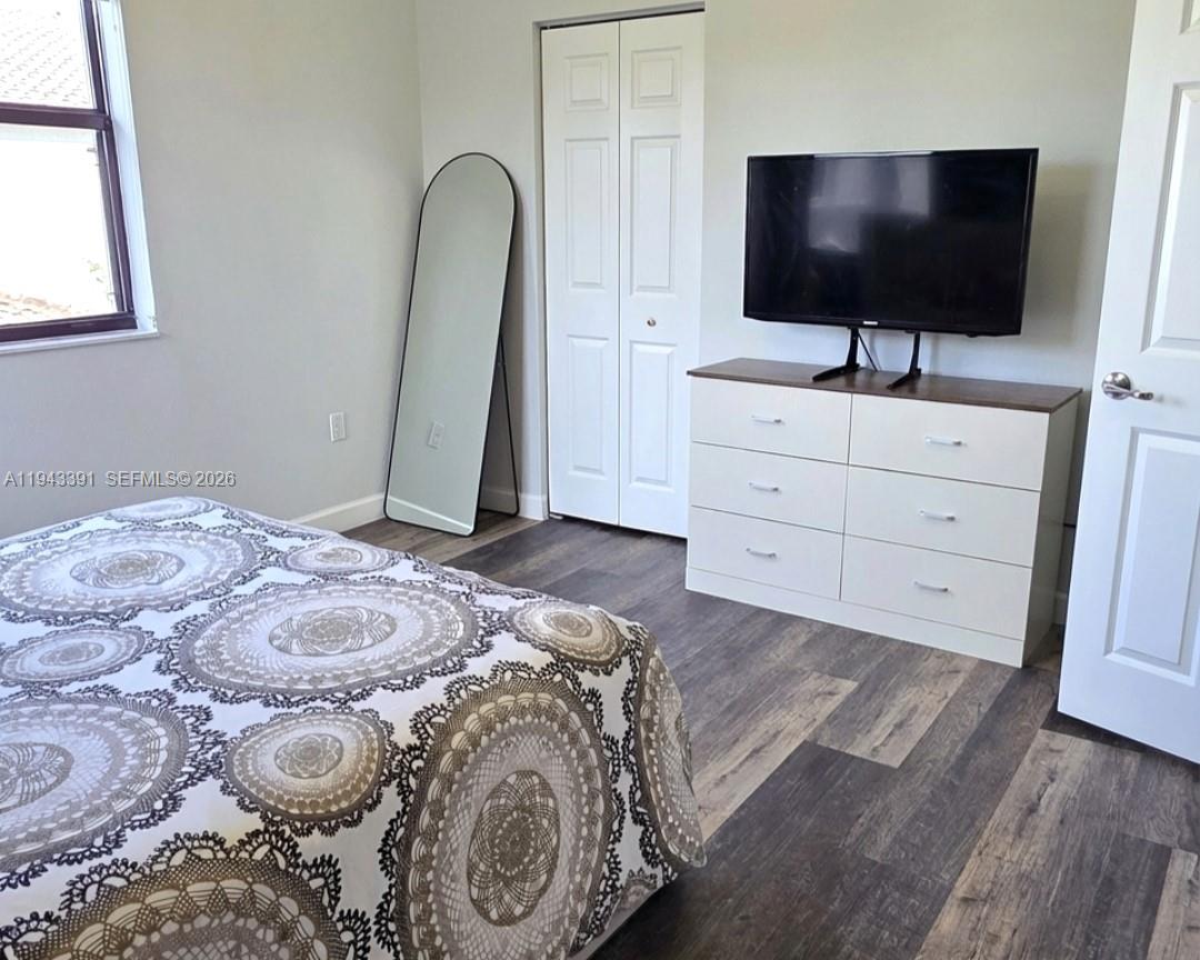 3203 Southeast 7th Street Homestead, FL 33033 - Photo 28 of 44 a bedroom with a bed and a flat screen tv