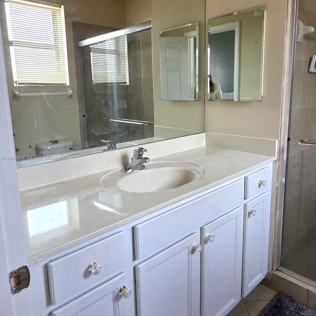 3203 Southeast 7th Street Homestead, FL 33033 - Photo 30 of 44 a bathroom with a sink and a mirror