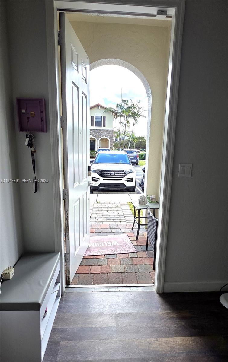 3203 Southeast 7th Street Homestead, FL 33033 - Photo 10 of 44 a view of an entryway with wooden floor and a livingroom