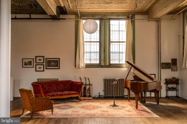 a bedroom with a bed and a lamp on dresser