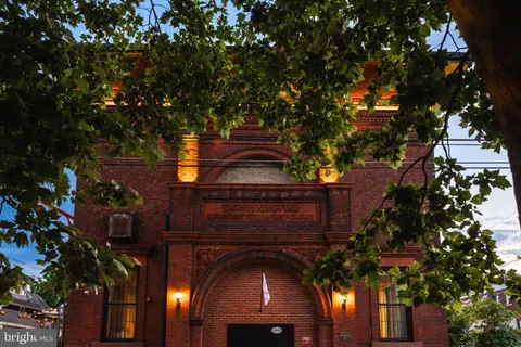 a vase of flowers sitting on a table in front of a door