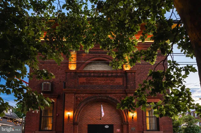 a vase of flowers sitting on a table in front of a door