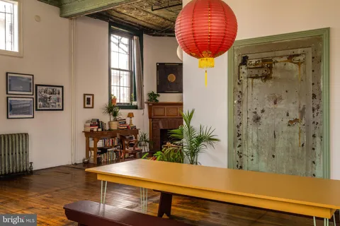 a living room with a fireplace furniture and a potted plant