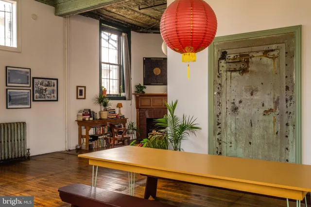 a living room with a fireplace furniture and a potted plant