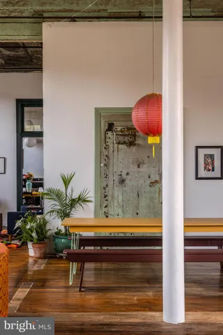 a living room with lots of furniture and a wooden floor