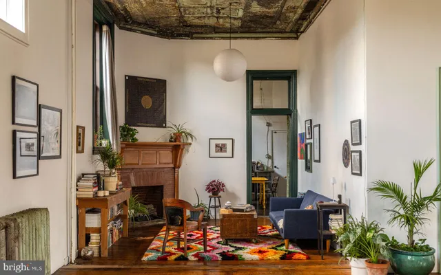 a living room with furniture and a fireplace
