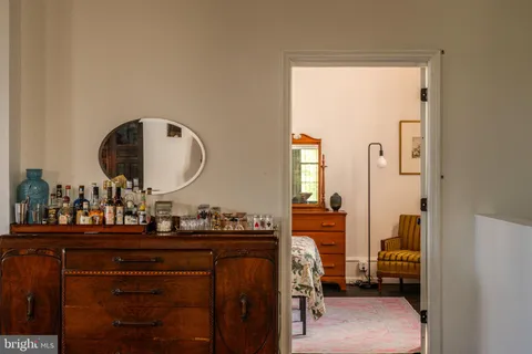 a kitchen with refrigerator a stove and wooden floor