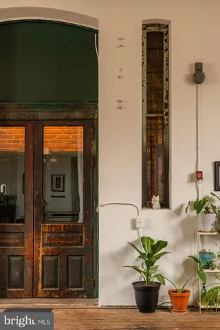 a living room with furniture a wooden floor and a large window
