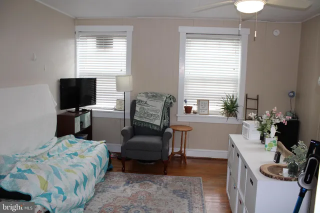 a bedroom with furniture and a flat screen tv