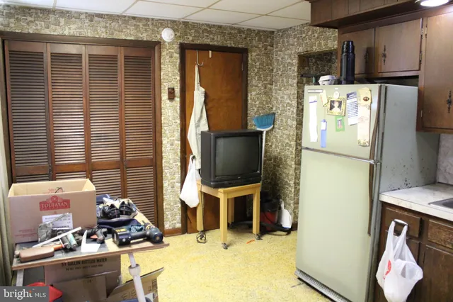 a kitchen with stainless steel appliances granite countertop a refrigerator and a stove