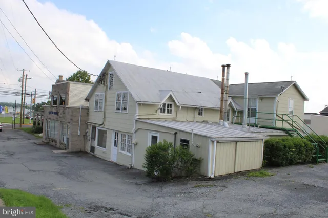 a view of a house next to a yard