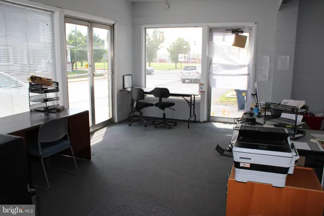a living room with furniture a table and a large window