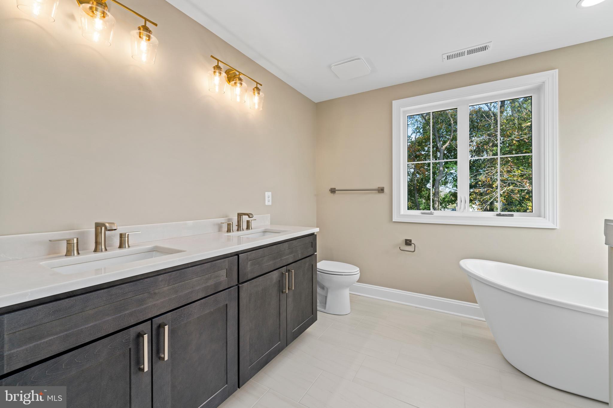 Stem Rd Union Bridge Union Bridge, MD 21791 - Photo 25 of 72 a bathroom with a granite countertop sink a toilet and a large mirror