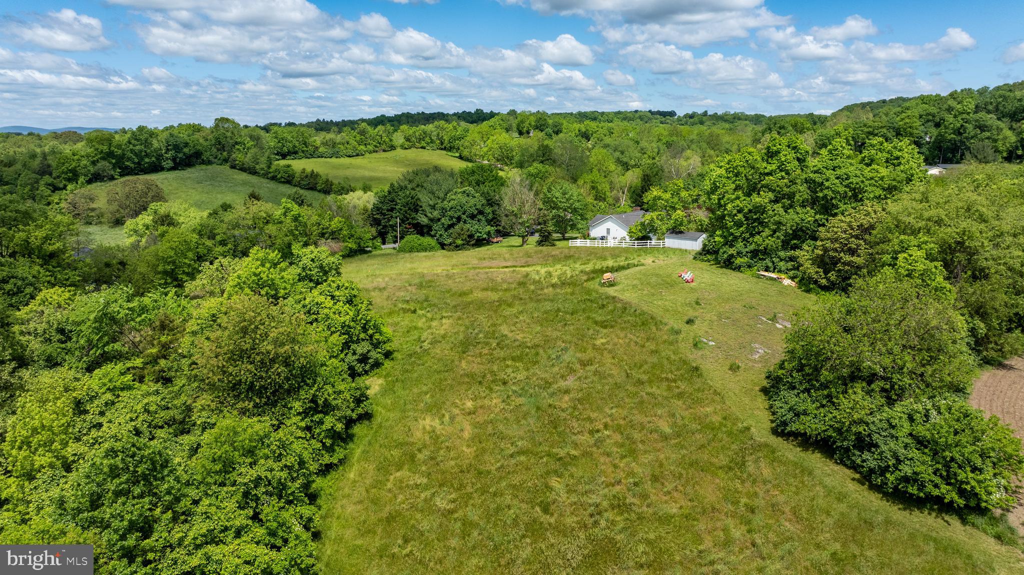 Stem Rd Union Bridge Union Bridge, MD 21791 - Photo 61 of 72 a view of a field with plants and a building in background