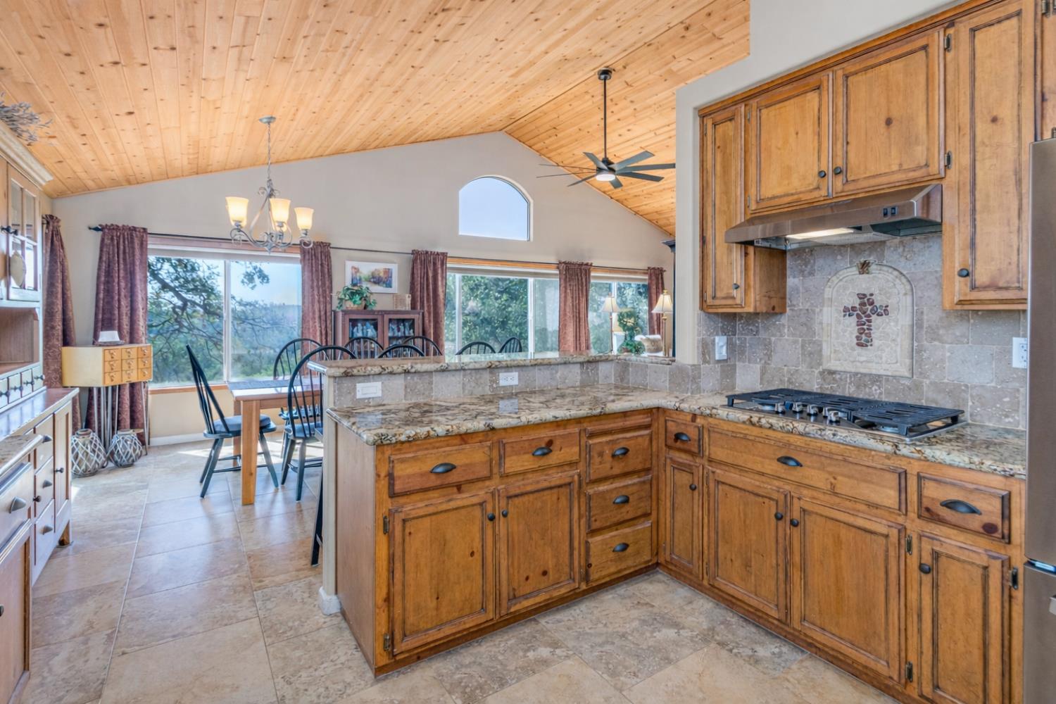 9290 Cramer Road Auburn, CA 95602 - Photo 21 of 67 a kitchen with stainless steel appliances granite countertop a stove a sink dishwasher and cabinets with wooden floor