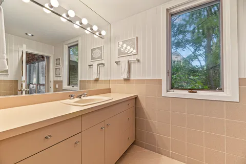 a spacious bedroom with a bed and a large window