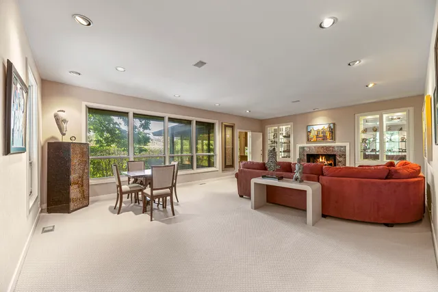 a living room with furniture and large windows