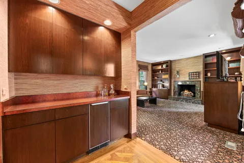 a living room with furniture a fireplace and a table