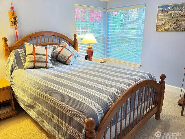 a bedroom with a bed and a large window