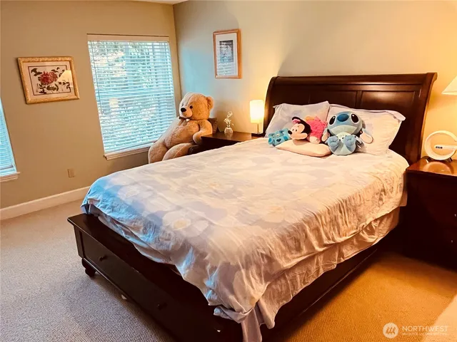 a bed sitting in a bedroom next to a window