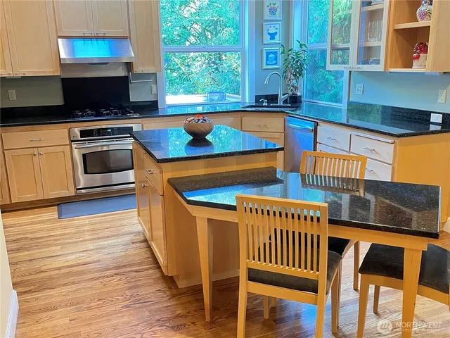 a kitchen with a table chairs and a stove