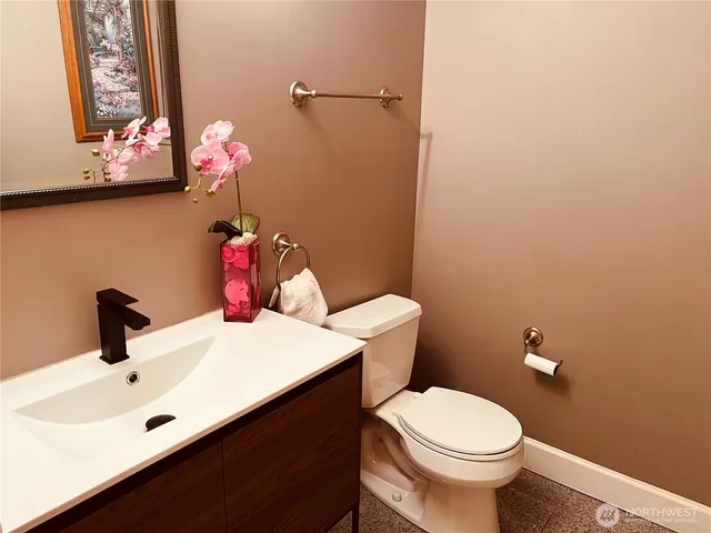 a bathroom with a sink mirror and toilet