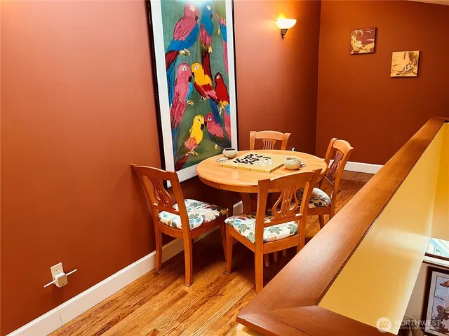 a view of a dining room with furniture and wooden floor