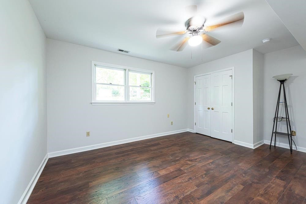 509 Compton Road Raleigh, NC 27609 - Photo 20 of 30 Lower level bedroom with double windows, ceiling fan, and double door closet. Bedroom 4