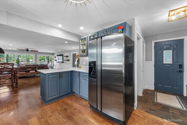 a kitchen with stainless steel appliances granite countertop a refrigerator and a counter top space