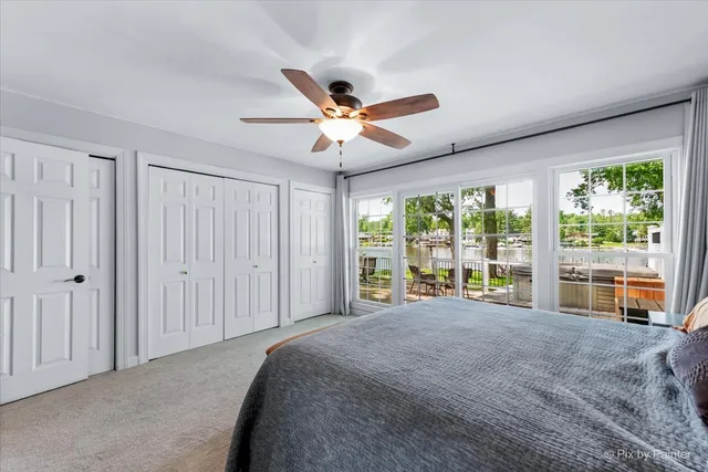 a large bedroom with a large bed and a large window with outer view