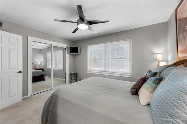 a bedroom with a large bed and a large window