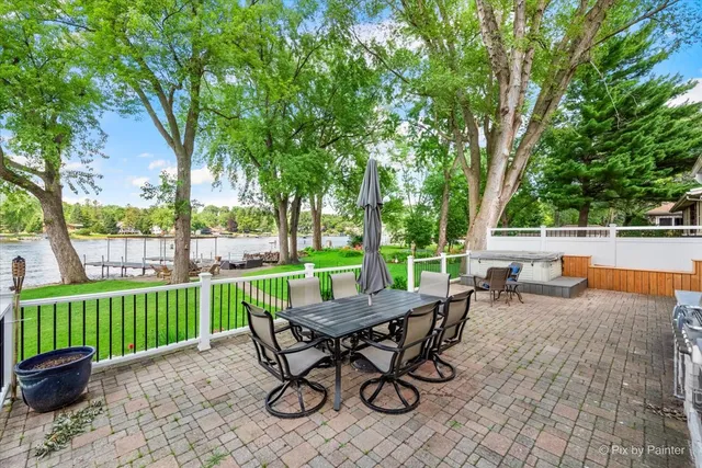 a view of a chair and table in backyard of the house