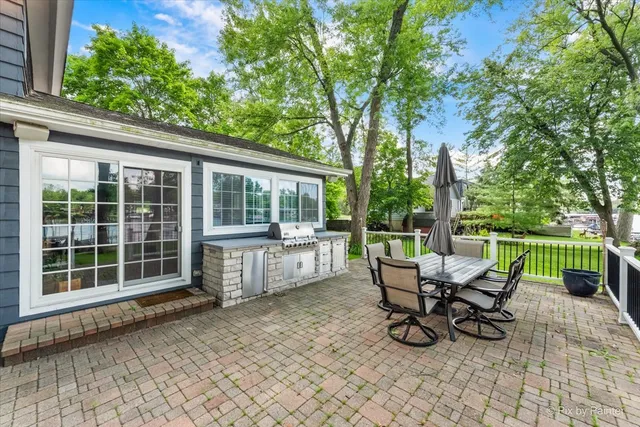 a view of a house with backyard and sitting area