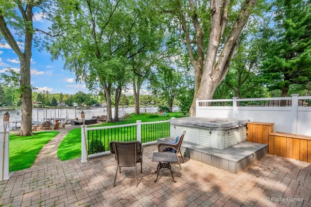 a view of a sitting area with large trees and a yard