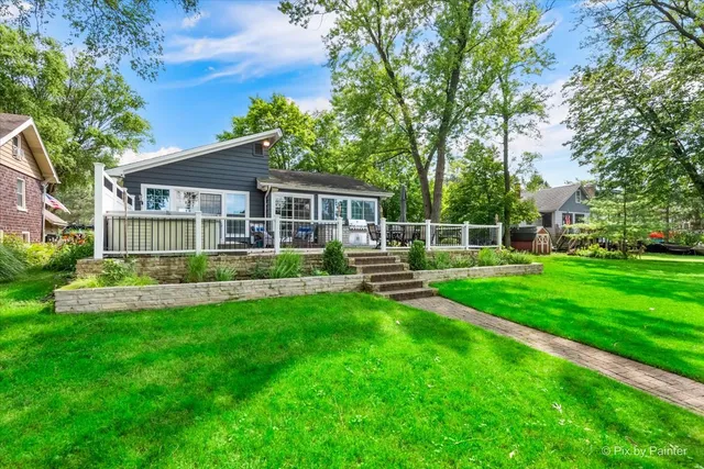 a front view of a house with a yard table and chairs