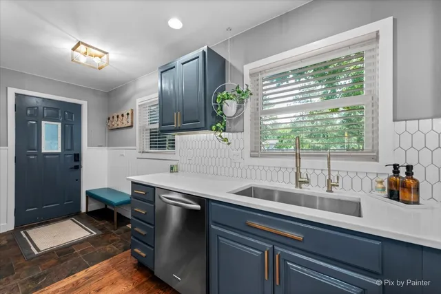 a kitchen with a sink and large window