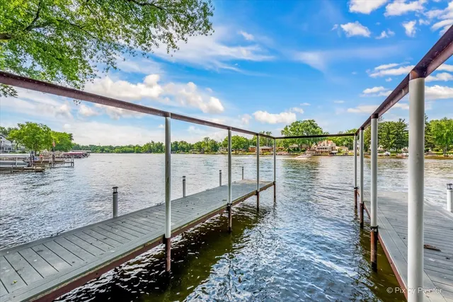 a view of a wooden deck and a backyard