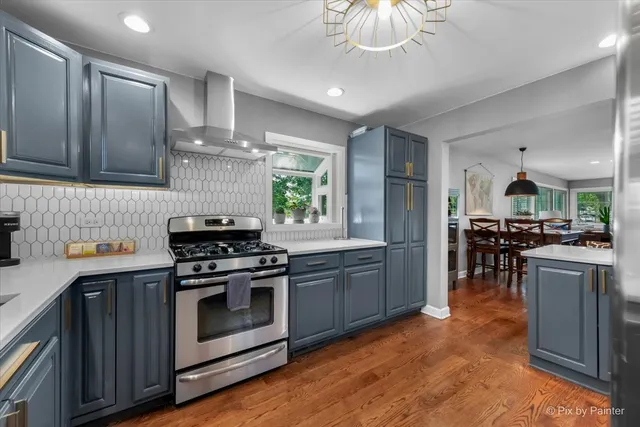 a kitchen with stainless steel appliances granite countertop a stove and a sink