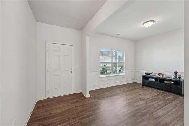 a view of a room with wooden floor and a window