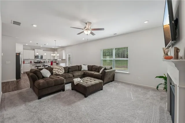 a living room with furniture fireplace and a window