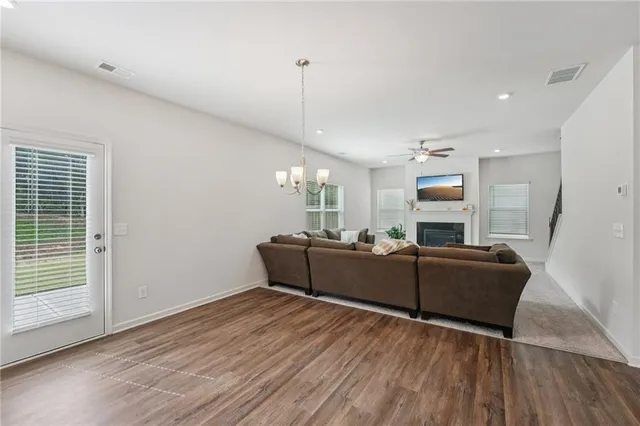 a kitchen with granite countertop a stove a sink and a refrigerator