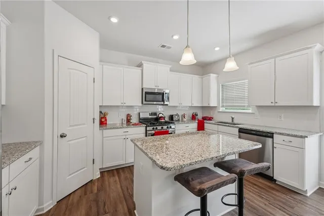 a kitchen with cabinets and wooden floors