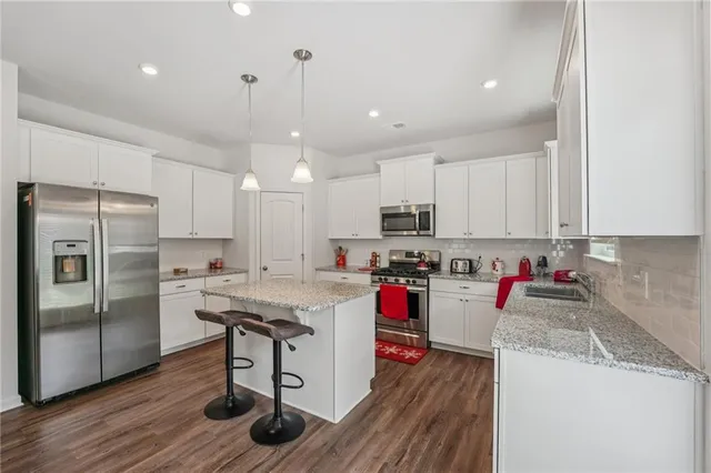 a kitchen with a sink stainless steel appliances and cabinets