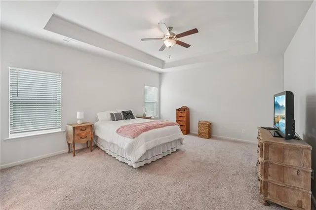 a spacious bathroom with a granite countertop sink a toilet a mirror and bathtub