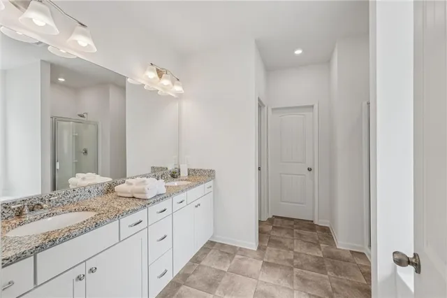 a bathroom with a double vanity sink mirror and toilet