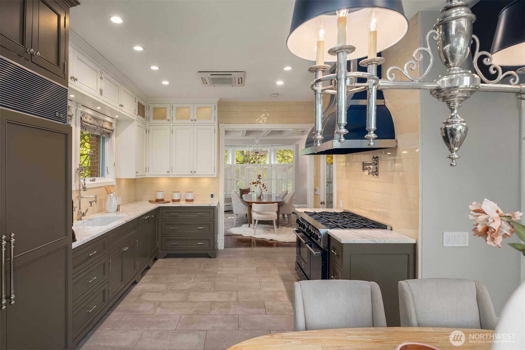 718 East Aloha Street, Unit 10 Seattle, WA 98102 - Photo 14 of 40 a kitchen with stainless steel appliances kitchen island granite countertop a stove a sink a refrigerator and a microwave
