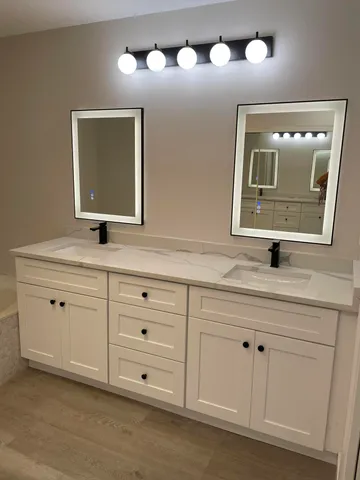 a bathroom with a double vanity sink and a mirror