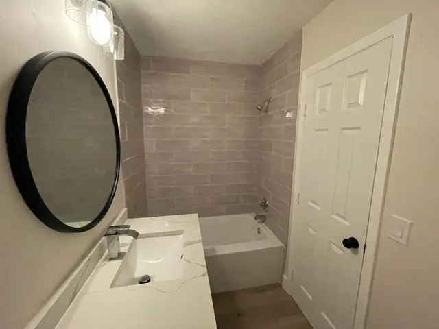 a bathroom with a sink a toilet and a mirror