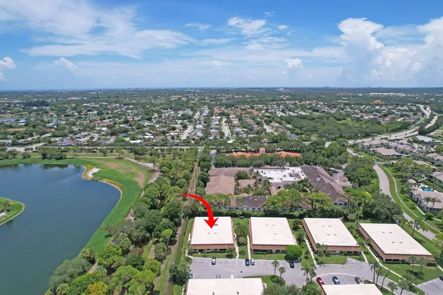 an aerial view of residential houses with outdoor space and lake view