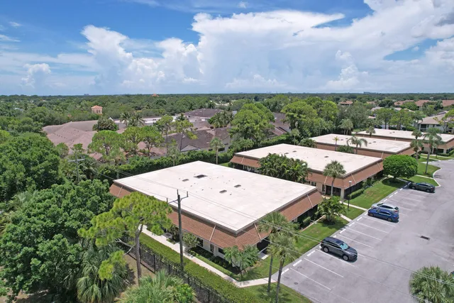 an aerial view of a house with a yard and lake view